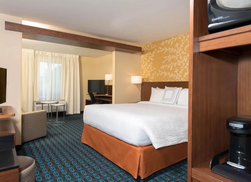 Fairfield Inn & Suites by Marriott Orlando Kissimmee/Celebration guest room with king bed and seating area