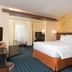 Fairfield Inn & Suites by Marriott Orlando Kissimmee/Celebration guest room with king bed and seating area