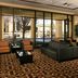 Courtyard by Marriott Kansas City East/Blue Springs lobby lounge with sofa seating and large windows in Blue Springs