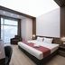 B1 Boutique Hotel Sofia in Sofia: modern guest room with king bed, desk, armchair, and large window