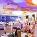 Sea Shore Garden Hotel Qingdao banquet hall with round tables and purple-lit ceiling