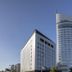 JR Hotel Clement Takamatsu in Takamatsu beside a tall curved tower against a clear sky