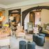 The Coed-Y-Mwstwr Hotel in Bridgend lounge with armchairs, lamps and an ornate arched mirror