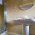 Aisleigh Guest House in Leitrim bathroom with shower, pedestal sink, and round mirror
