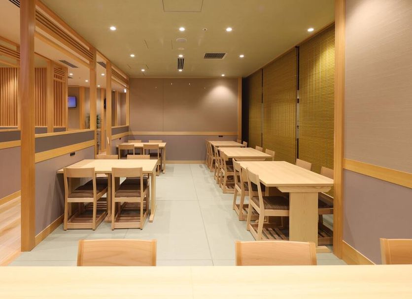 Dining area at Onyado Nono Asakusa Bettei in Tokyo with wooden tables and chairs