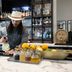 AC Hotel Fort Worth Downtown bartender preparing a cocktail at a marble bar with citrus and bottles