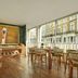 The Cura Hotel Kensington, London breakfast area with large windows and street views