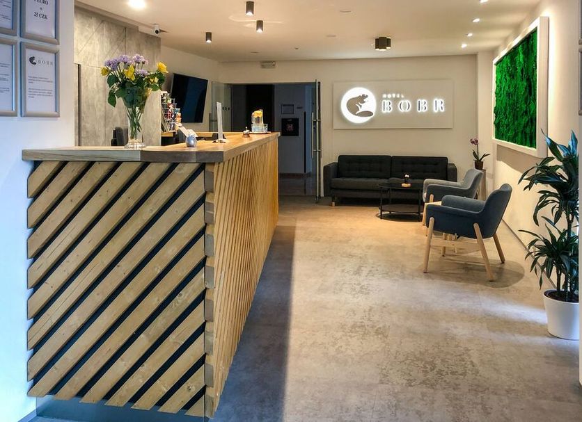 Hotel Bobr in Chomutov lobby with front desk, seating area, and modern decor