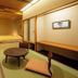 Yusen Shidate in Hanamaki: Japanese-style room with tatami mats, low table, and bed