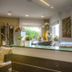 Hotel La Baia reception desk with potted plants and sea view through windows in Diano Marina