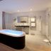 Petit Hôtel Confidentiel in Chambéry: modern bathroom with freestanding soaking tub, double vanity and walk-in shower