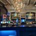 OYO The Leven Felixstowe bar with backlit counter, bottle shelves and hanging chandelier