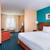 Fairfield Inn & Suites by Marriott Galesburg guest room with king bed, sofa, desk and TV