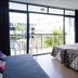 Ibiza Rocks Hotel in Sant Antoni de Portmany: bright room with balcony, two beds, and seated area