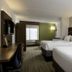 Holiday Inn Express & Suites Charlotte Arpt-Belmont in Belmont guest room with two beds and workspace