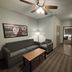 AmericInn by Wyndham Galesburg room with sofa, chair, table and ceiling fan