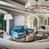 The Ritz-Carlton Orlando Grande Lakes lounge with curved sofa, blue chairs and modern chandelier