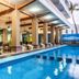 Hotel Playa Bonita in Mazatlán with an outdoor pool beside a covered patio seating area