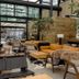 Rodavento Valle de Bravo lobby lounge with mustard sofa, wood tables and glass walls in Valle de Bravo