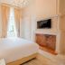 Château De Noirieux in Briollay, elegant guest room with fireplace, TV, and tall window
