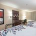 Red Roof Inn Raleigh Southwest - Cary guest room with two beds, desk, TV and curtained window