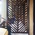 Le Cou de Tou Village Resort in Roxas with a carved wooden slat doorway and tropical plants