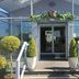 Beamish Park Hotel entrance with glass doors, potted topiary and flower decorations in Newcastle upon Tyne