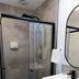 Garden Motor Inn Gundagai bathroom with glass shower, vanity sink and round mirror