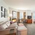 Residence Inn by Marriott New Bedford Dartmouth suite with sofa, desk, bed, and dining table