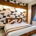 Hotel 88 Mangga Besar Viii, Jakarta: modern guest room with geometric accent wall and city view window