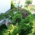 Gultepe Apartments in Kusadasi with exterior stairs beside lush garden and white building