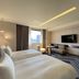 Monarch Plaza Hotel in Taoyuan City guest room with two beds, sofa, TV and city view
