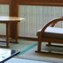 Kameya Ean in Izu with wooden lounge chairs and a table beside a window with vertical slats