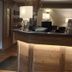 Landhotel Ewerts in Nuerburg reception desk with warm lighting and wood-paneled front