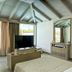 Female Resort, San Felice Circeo guest room with vaulted ceiling, TV, mirror and large windows