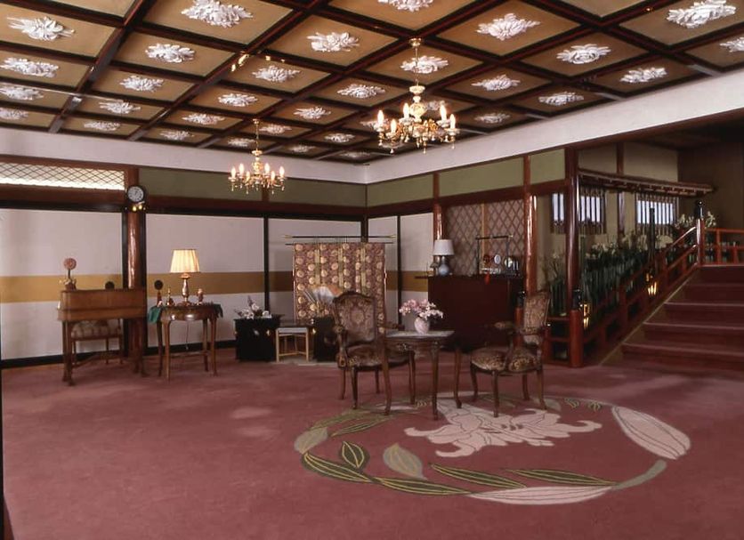 Kurhaus Ishibashi Ryokan in Shimoda lobby with chandeliers, carved ceiling, and staircase