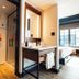 Hammetts Hotel in Newport bathroom vanity beside shower and bedroom with large window view