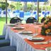 Hotel Jaragua Veracruz dining table with floral centerpiece beside poolside lounge chairs