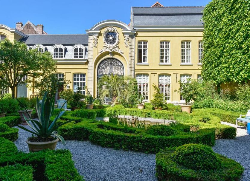 B&B The Verhaegen in Ghent, elegant historic hotel with manicured garden and yellow facade