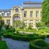 B&B The Verhaegen in Ghent, elegant historic hotel with manicured garden and yellow facade