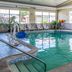 Quality Inn and Suites Ann Arbor Hwy 23 indoor pool with lounge chairs and large windows in Ann Arbor