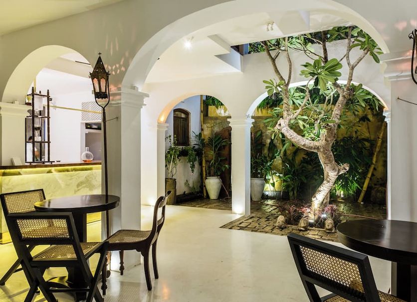 Prince of Galle in Galle courtyard dining area with arched walkways, lanterns and a tree feature