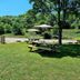 Hotel Enzo Green Clermont Ferrand, Coude in Coudes: shaded picnic tables on a grassy lawn