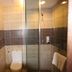 Gem Beach Resort in Kuala Terengganu bathroom with walk-in glass shower, toilet and vanity