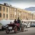Hadley's Orient Hotel in Hobart, horse-drawn carriage on a street beside historic buildings and parked cars
