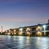 Red Roof Inn Vincennes exterior at dusk with lit rooms and empty parking lot