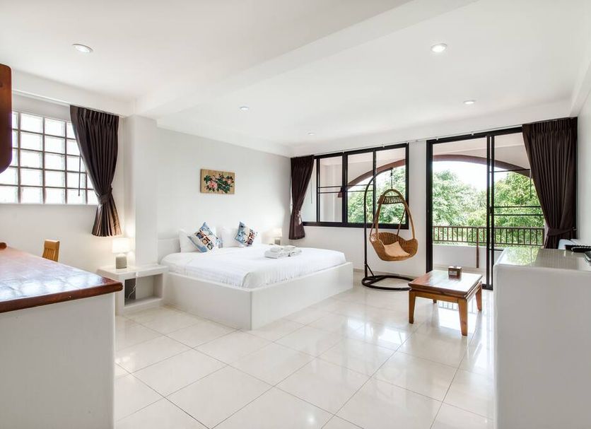 Prinz Garden Villa in Hua Hin room with two beds, balcony doors, and hanging chair