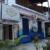 La Villa Creole in Pondicherry, white-and-blue hotel exterior with sign, entrance and potted plants