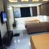 The Unicontinental - Campus Accommodation in Mumbai room with two beds and wall-mounted TV