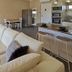 Comfort Inn & Suites King Avenue in Sale, suite with sofa, kitchen bar, dining area and bedroom